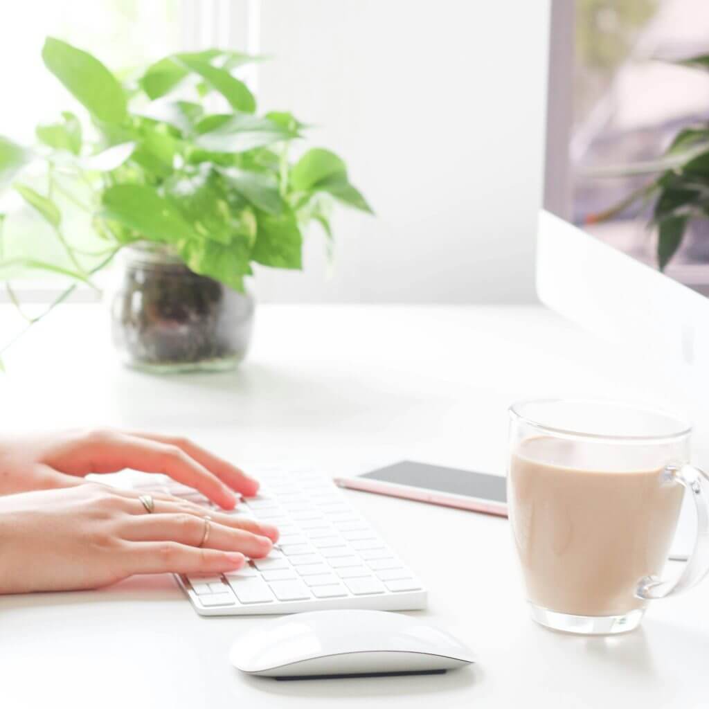 Les mains d'une femme qui travaille sur son clavier d'ordinateur
